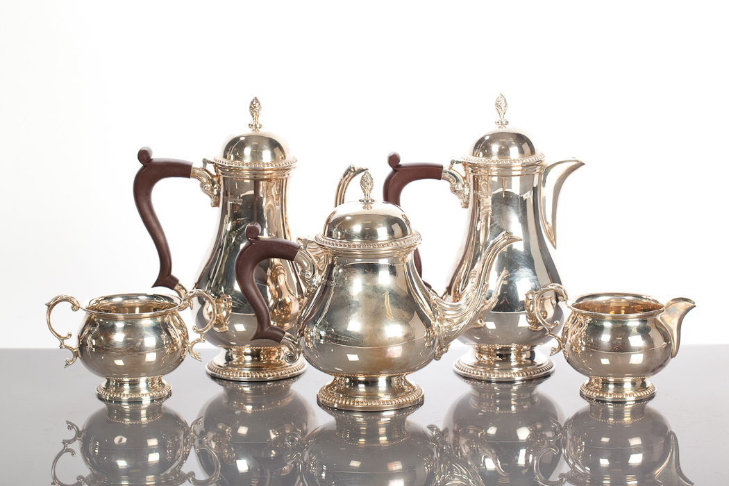 SILVER FIVE PIECE TEA SERVICE of baluster form, with gadrooned borders and pineapple finials,