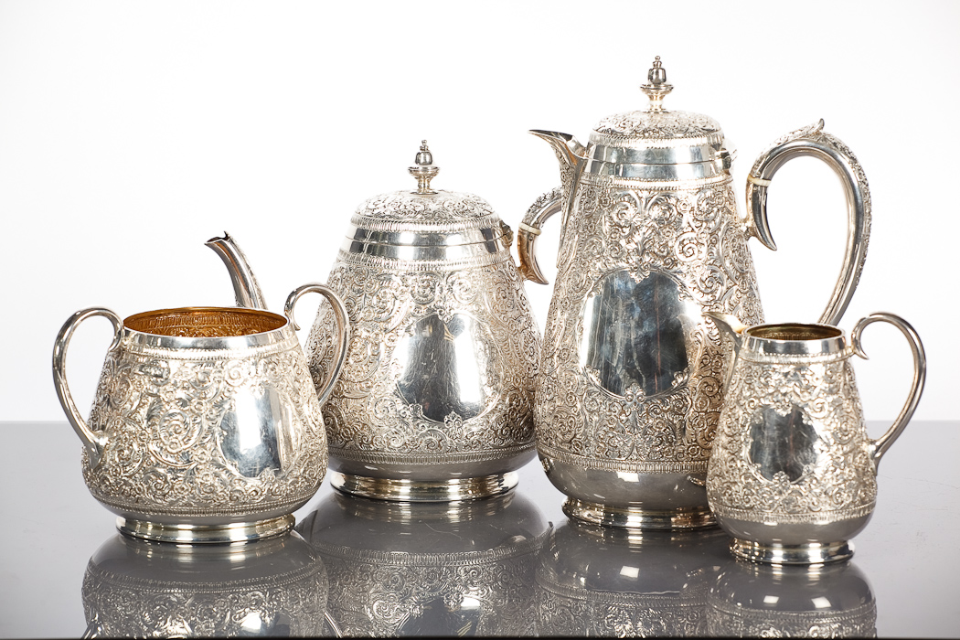 VICTORIAN SILVER FOUR PIECE TEA SERVICE of tapered cylindrical form, having dense foliate chased