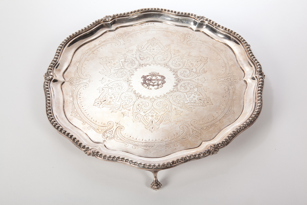 VICTORIAN SILVER TRAY of serpentine circular form, having beaded border and chased foliate centre,