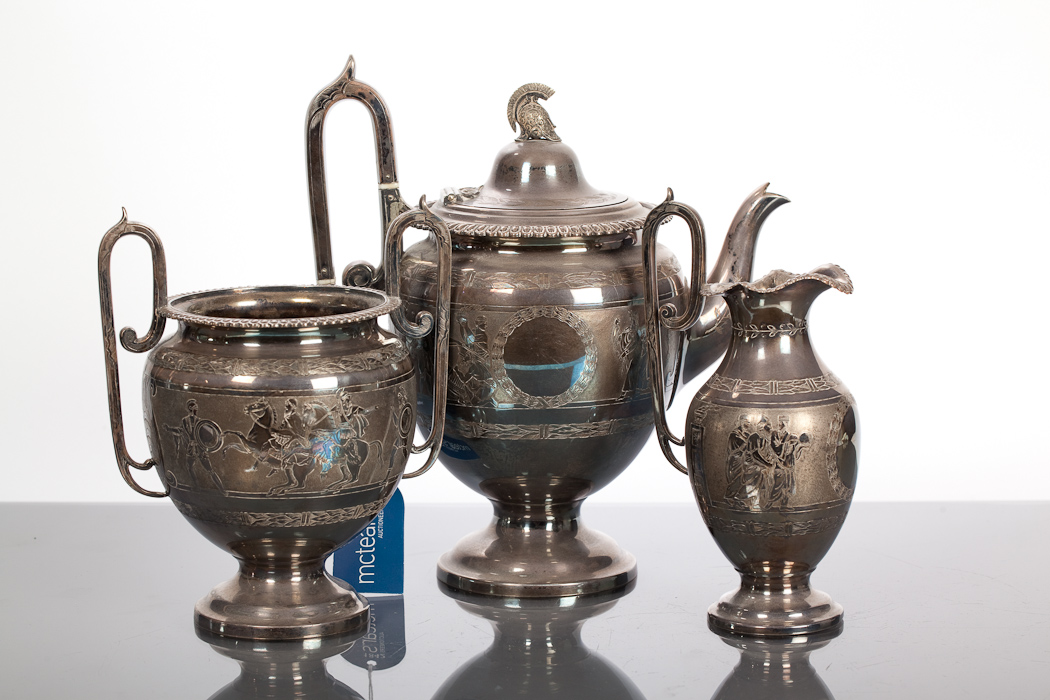 LATE VICTORIAN SILVER PLATED THREE PIECE TEA SERVICE comprising a teapot, sugar and cream, the