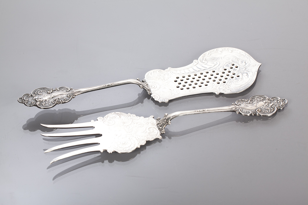 EARLY 20TH CENTURY WMF SILVER PLATED FISH SERVERS with fish and c-scroll decoration, marked, 28cm