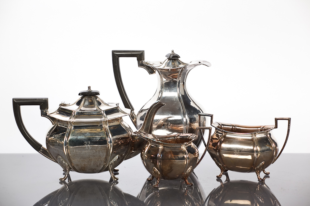 SILVER FOUR PIECE TEA SERVICE of bombe form,comprising teapot, water pot, sugar and cream,