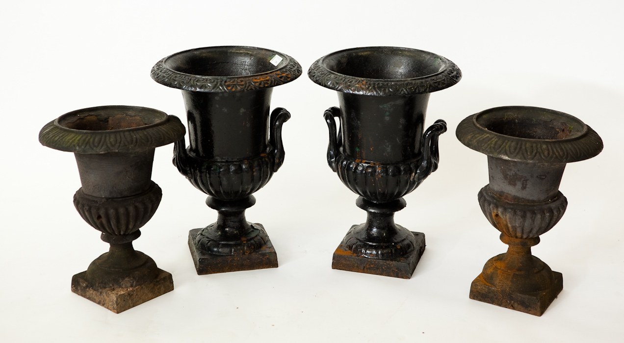 TWO PAIRS OF BLACK PAINTED CAST IRON GARDEN URNS 43cm high and 36cm high respectively