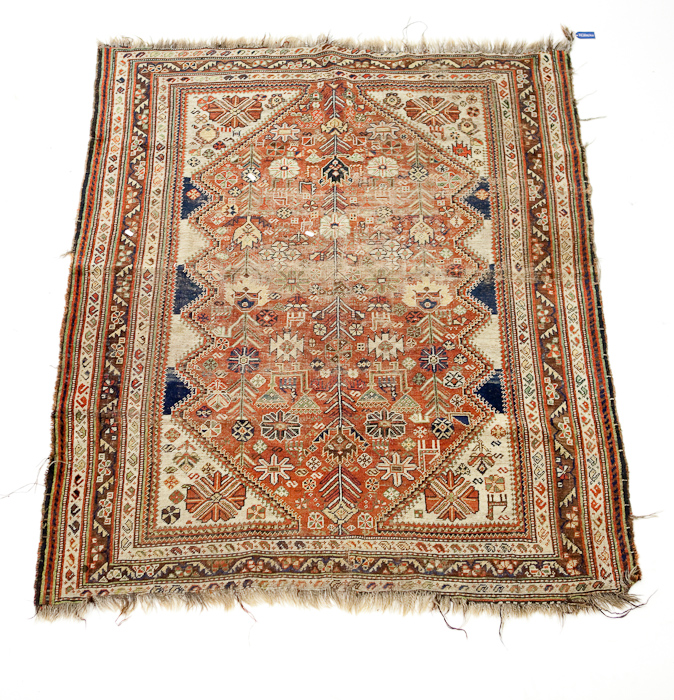 ANTIQUE CAUCASIAN RUG the field with serrated floral lozenge panel, within a triple border, 180cm