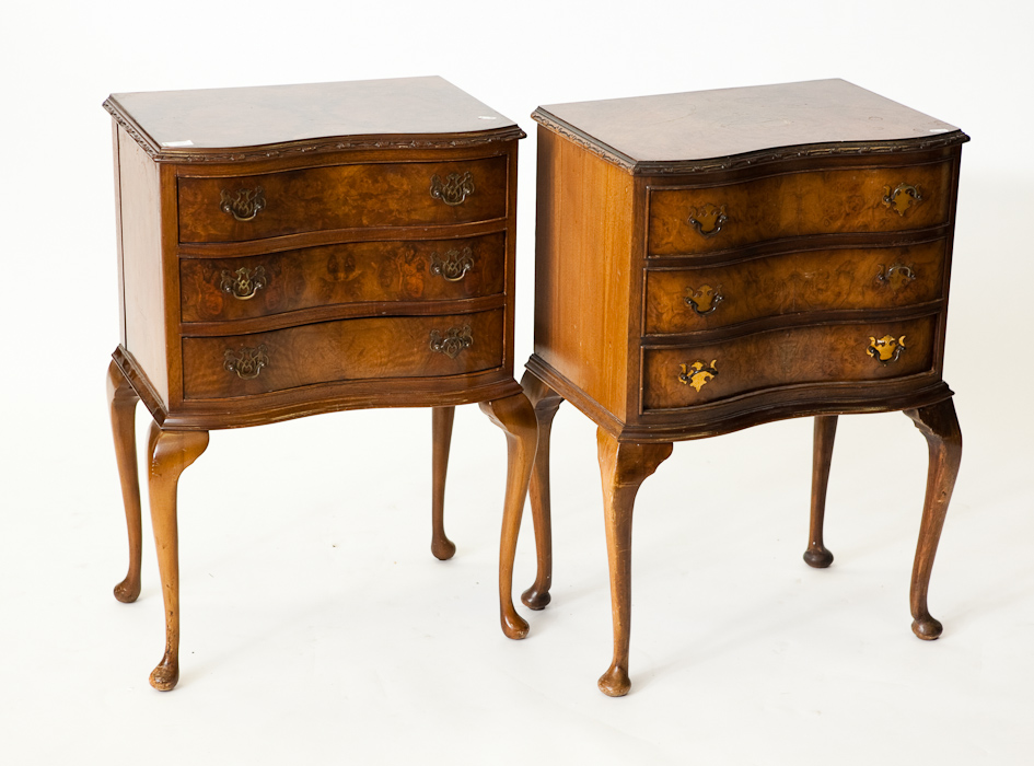 PAIR OF SERPENTINE WALNUT BEDSIDE CHESTS with three drawers on cabriole legs, 79cm high