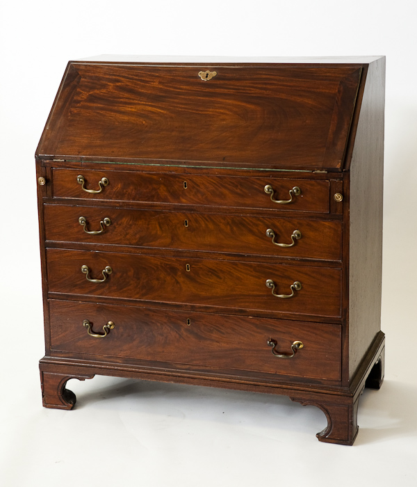 GEORGE III MAHOGANY BUREAU the fall front enclosing fitted interior above four long graduated
