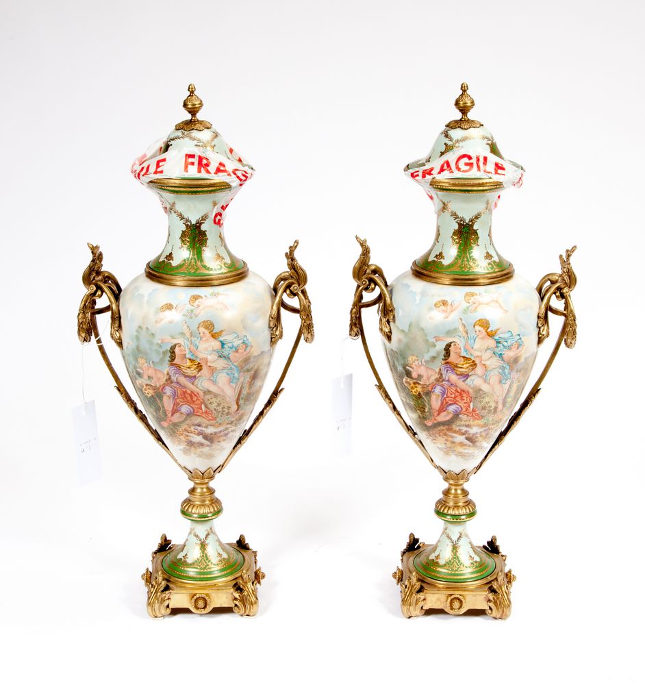 A PAIR OF SEVRES STYLE PORCELAIN AND BRASS MOUNTED VASES AND COVERS, 
each with two leaf cast