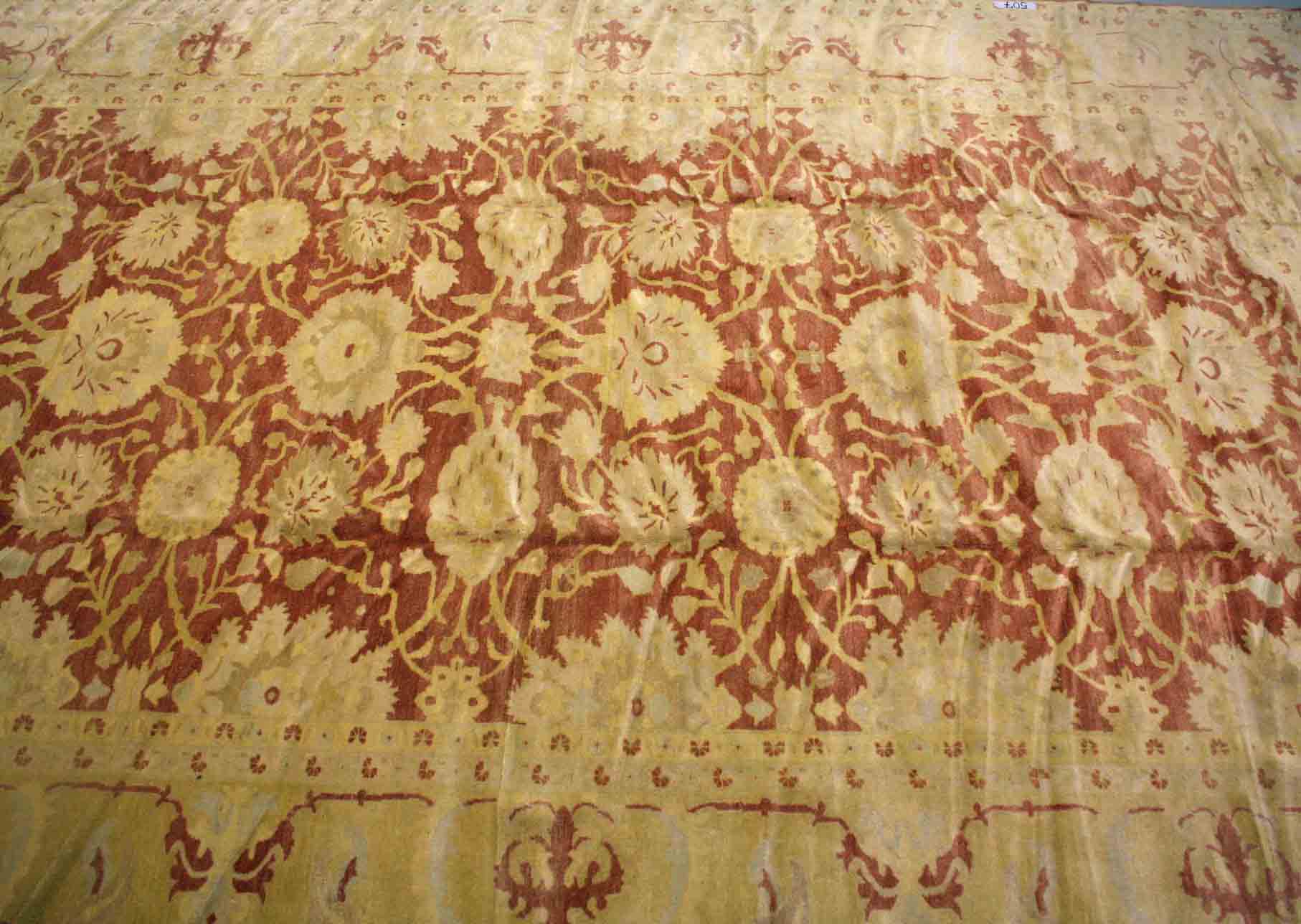 AN ATTRACTIVE ZIEGLER STYLE CARPET,
the iron red and mustard ground with stylised flowers in three
