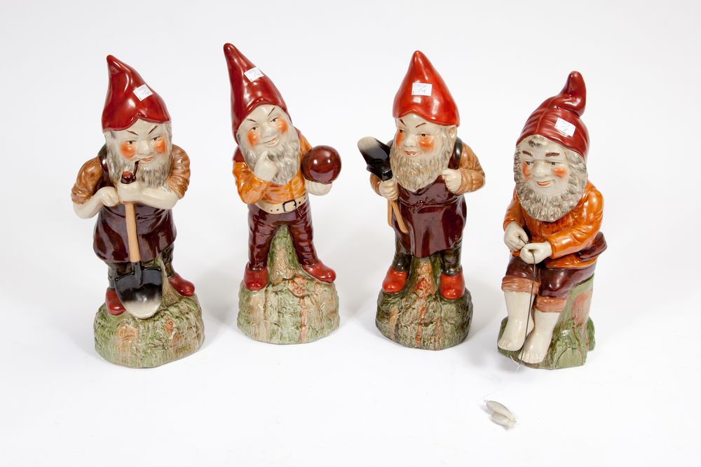 A SET OF FOUR MODERN CERAMIC FIGURES, 
each modelled as a garden gnome holding different implements,