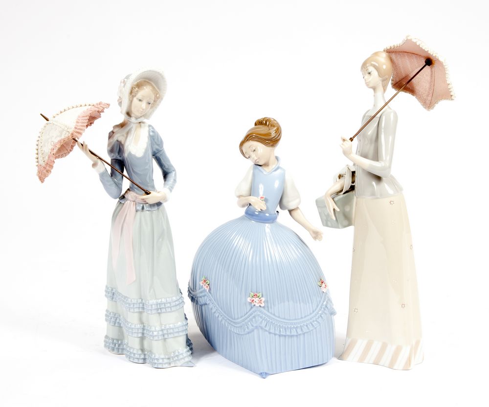 TWO LLADRO FIGURES,
each modelled after a young lady holding a parasol, 13in (33cm), and another