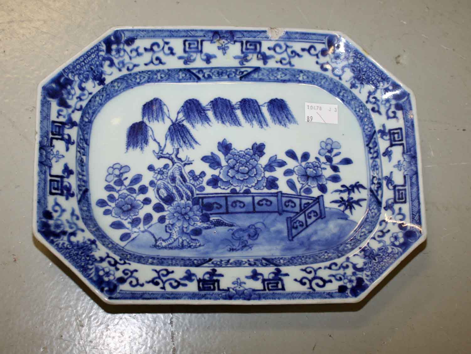 AN 18TH CENTURY CHINESE BLUE AND WHITE MEAT PLATTER,
decorated  with a garden view, 11.25in (29cm)