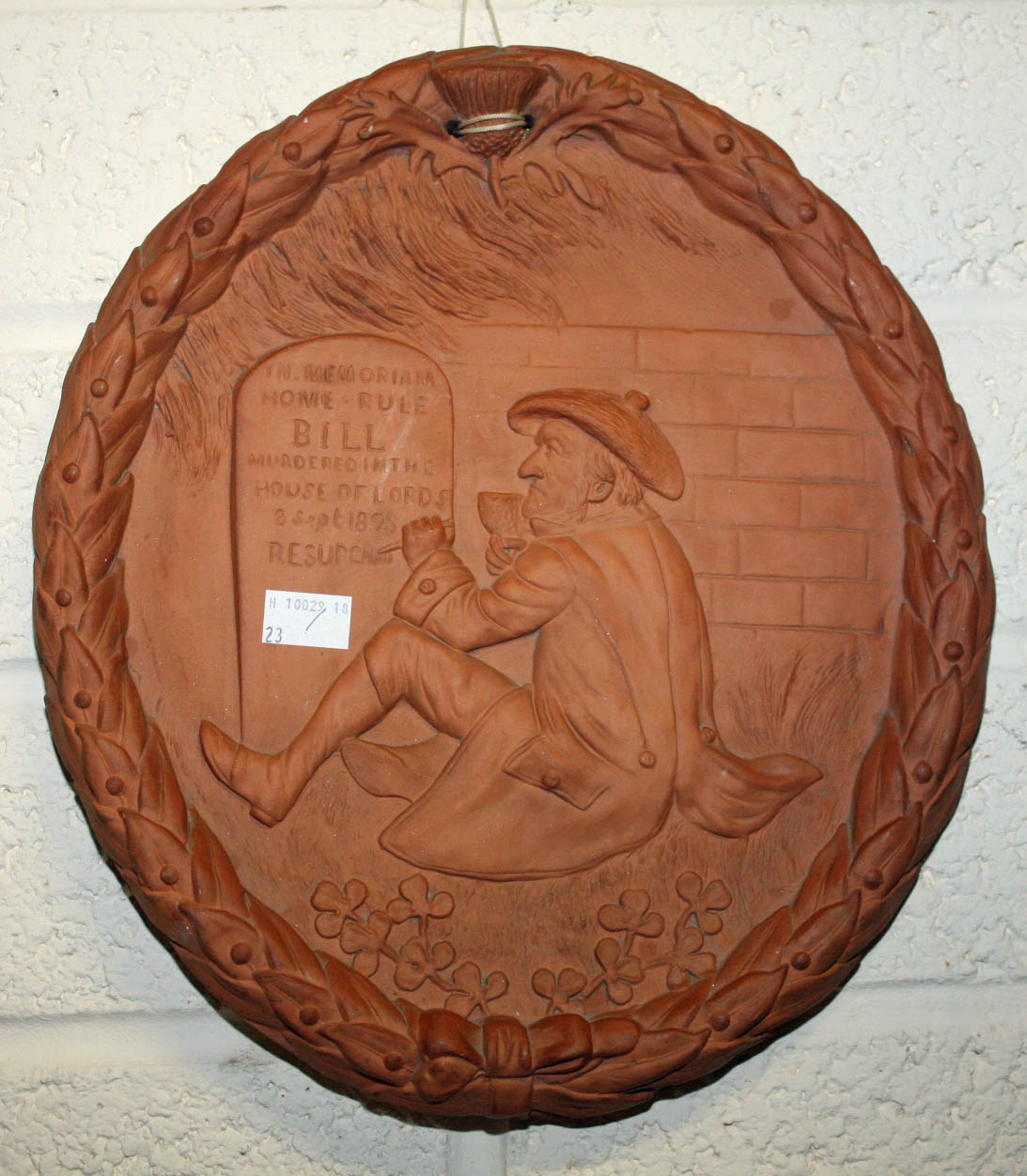 A 19TH CENTURY UNUSUAL OVAL TERRACOTTA HOME RULE PLAQUE, 
relief moulded with a man in tail coat and