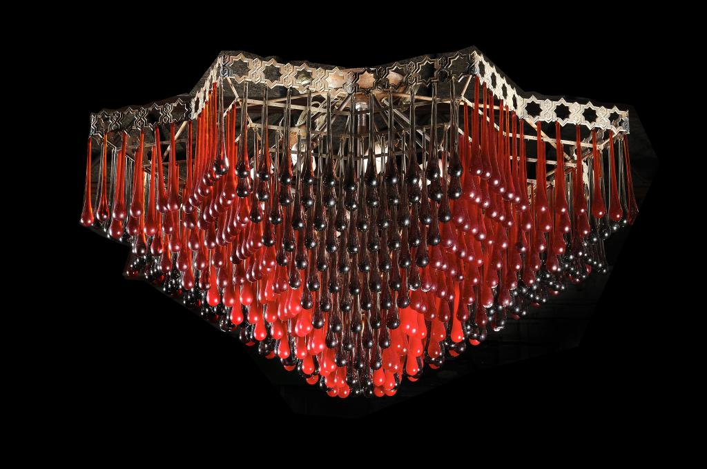 A STYLISH 1970S RED AND SMOKE GLASS TIERED CHANDELIER,    probably Italian, the pierced metal frame