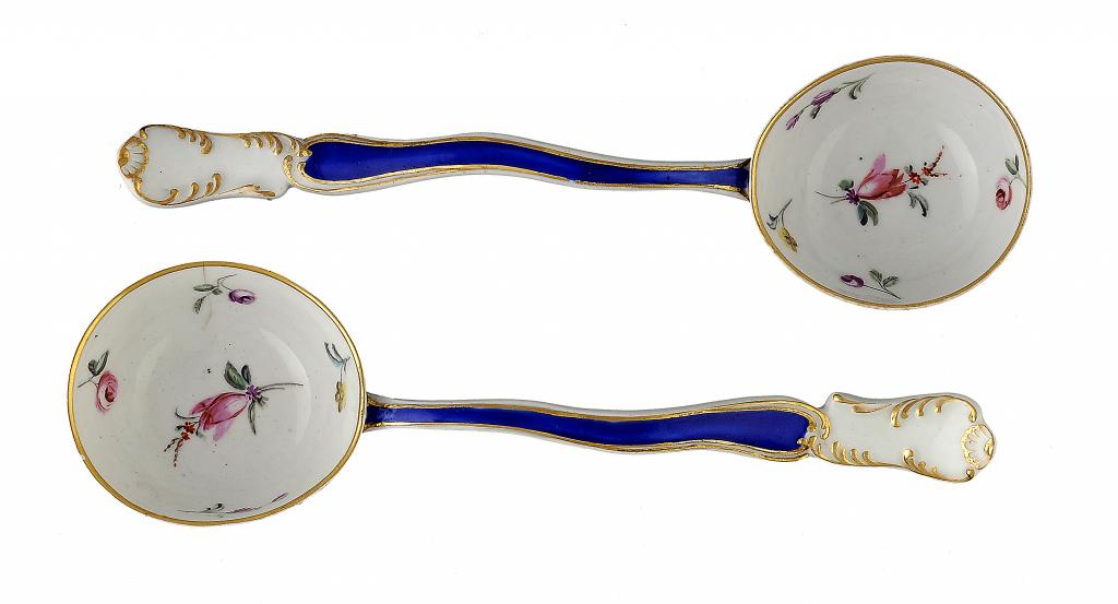 A RARE PAIR OF DERBY ROCOCO CREAM LADLES  painted with flowers to the interior and exterior of the