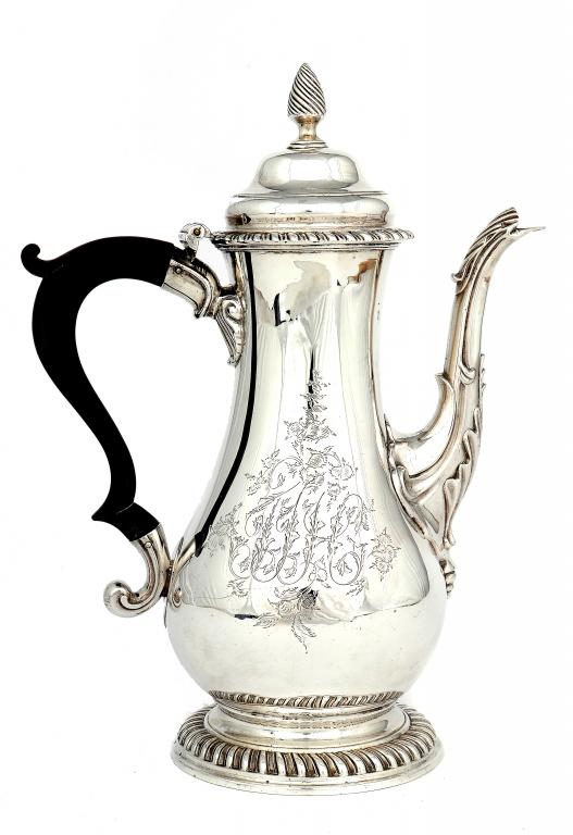 A GEORGE III COFFEE POT of baluster shape with ogee lid and gadrooned rims,  maker WT, probably