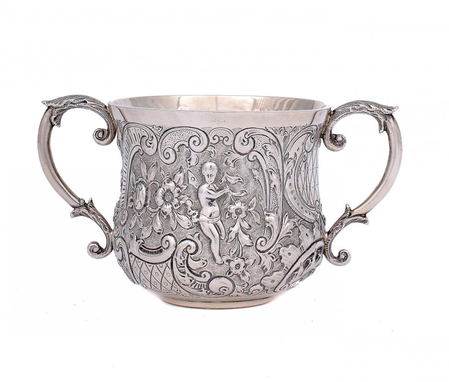 A VICTORIAN PORRINGER  by Wakley & Wheeler, London 1897, crisply chased with winged figures and