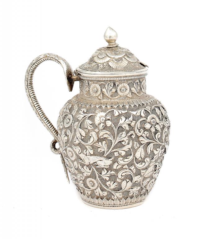 AN INDIAN COLONIAL REPOUSSÉ MUSTARD POT  by Oomersi Mawji,  Bhuj,  with cobra handle and decorated