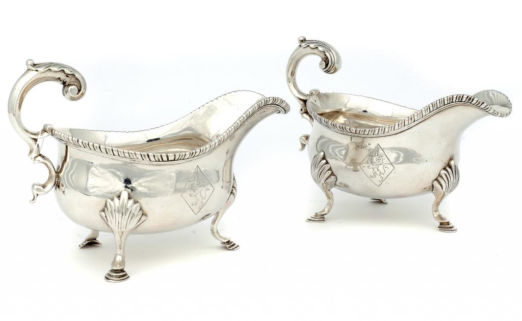 A PAIR OF GEORGE III SAUCE BOATS  with flying scroll handle and gadrooned rim, engraved with