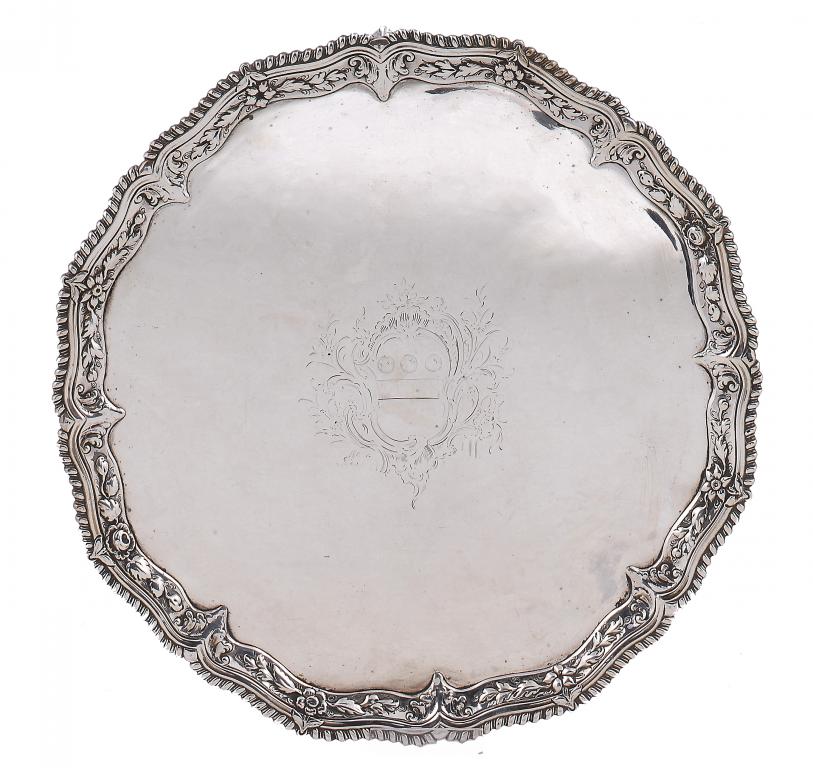 A GEORGE III SALVER engraved with contemporary armorials, shaped border with foliate cavetto and