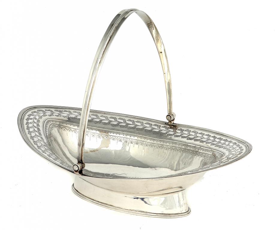 A GEORGE III CAKE BASKET   with pierced and engraved border and reeded handle and rim,  maker WA in