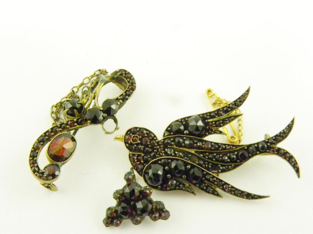 A GARNET SWALLOW BROOCH AND ANOTHER, C1900