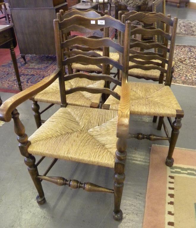 A SET OF FIVE ASH LADDER BACK DINING CHAIRS, RUSH SEATED, INCLUDING  AN ELBOW CHAIR