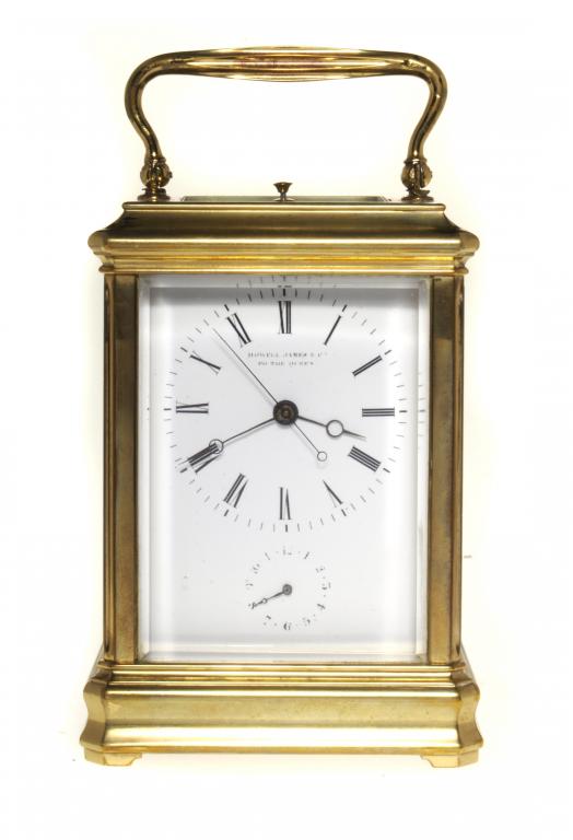 A FRENCH BRASS CARRIAGE CLOCK signed on the enamel dial HOWELL JONES & CO TO THE QUEEN with