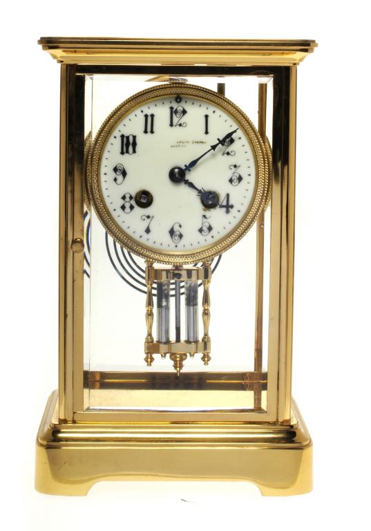 AN FRENCH BRASS CLOCK with primrose enamel dial signed....COMPANY BOSTON, arabic chapters and