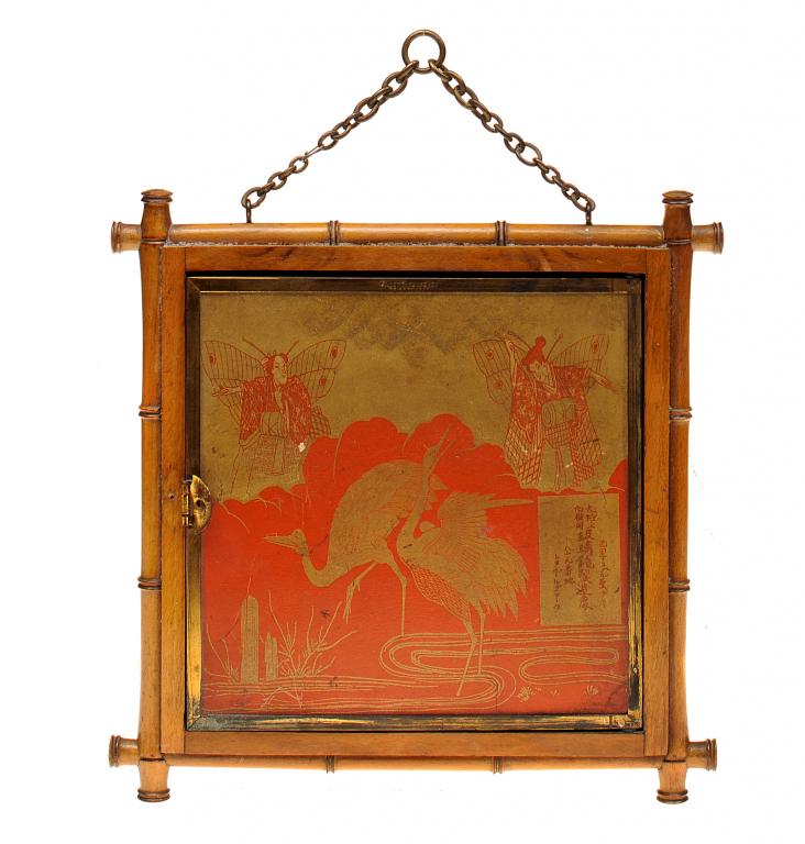 AN AESTHETIC MOVEMENT FOLDING MIRROR the lacquered brass framed wings backed with red and gilt