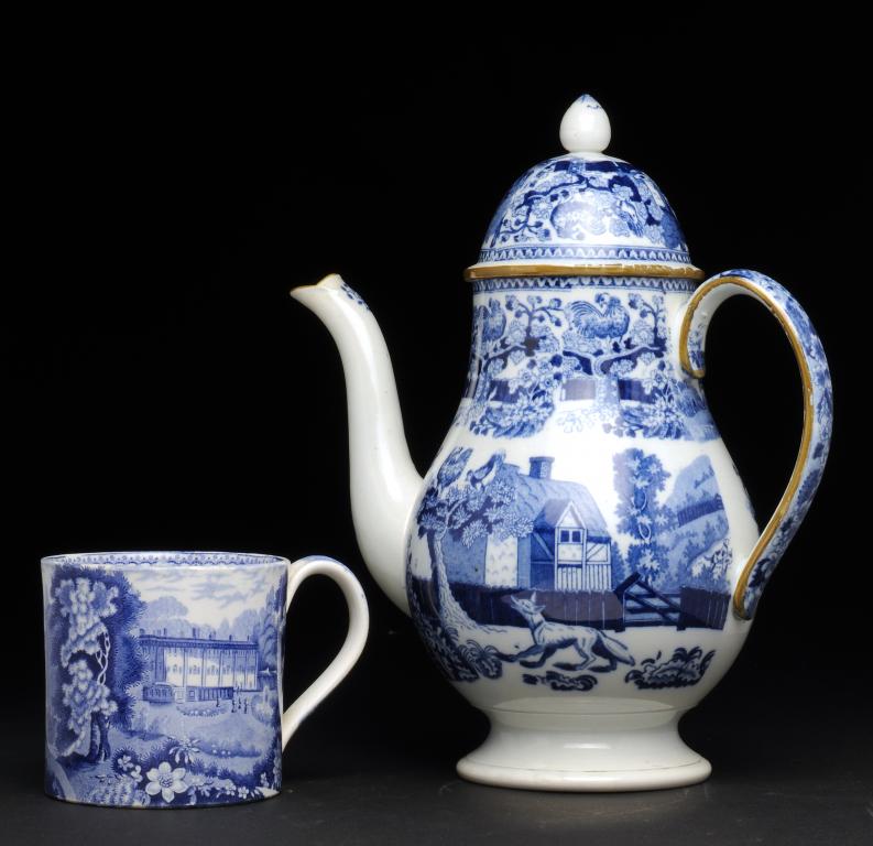 A BLUE PRINTED PEARLWARE COFFEE POT AND COVER with a fable pattern, the rims and handle outlined