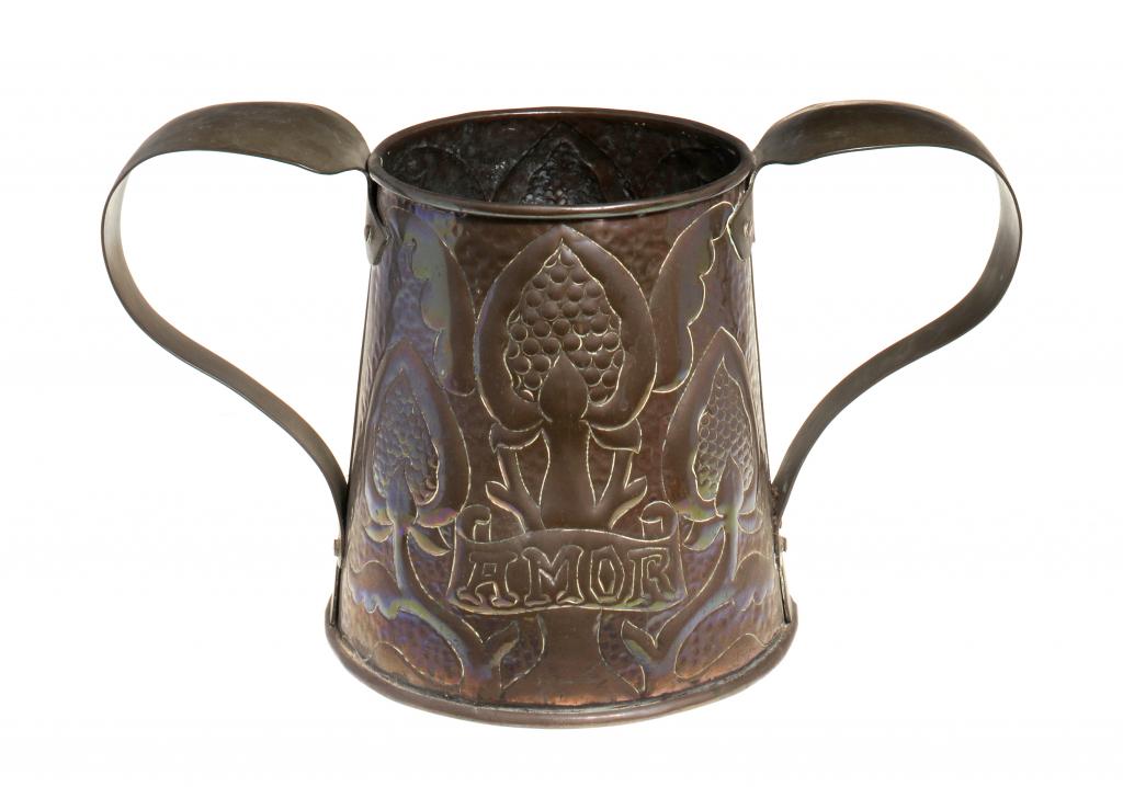 AN ARTS & CRAFTS COPPER VASE MADE FOR LIBERTY & CO with brass whiplash handles and repoussé