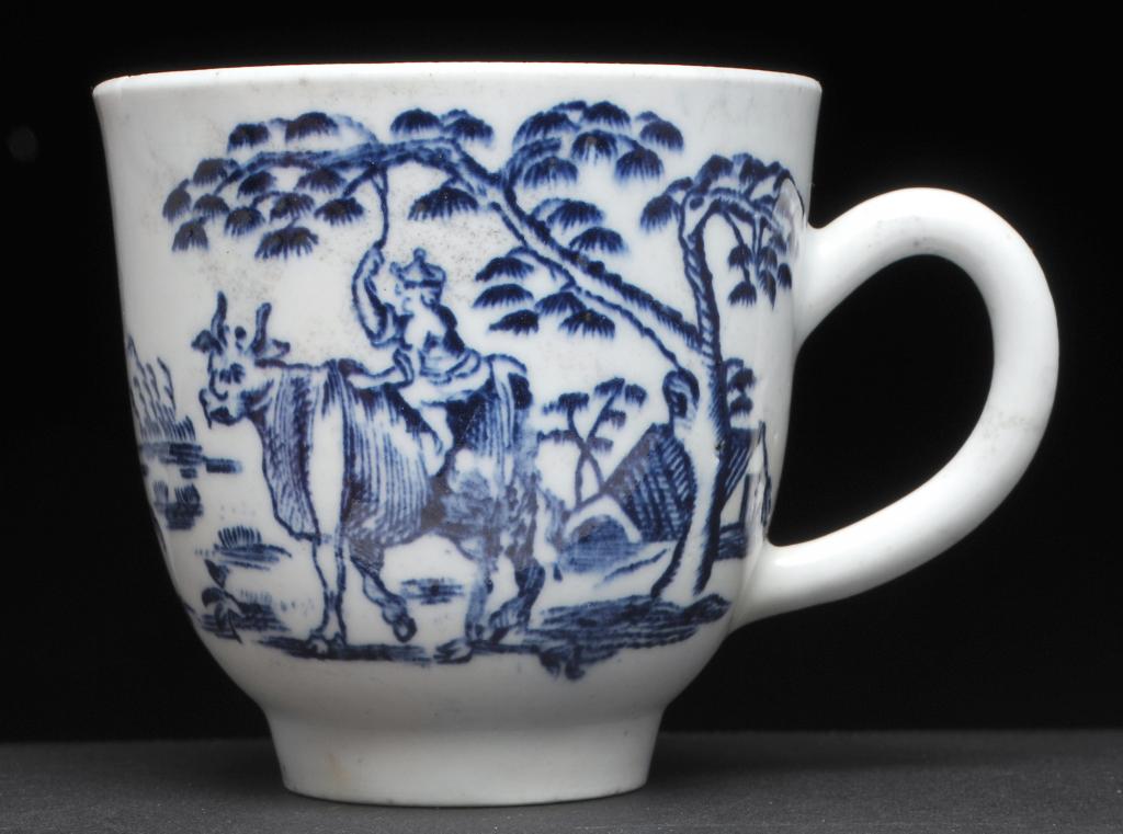 A DERBY OR POSSIBLY ISLEWORTH BLUE AND WHITE COFFEE CUP of slightly flared shape with roll handle,