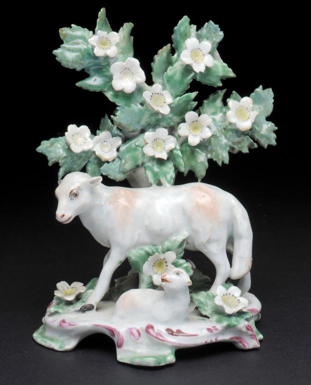 A BOW EWE AND LAMB GROUP set before a leafy forked tree on scrolling puce and green edged base, 13cm