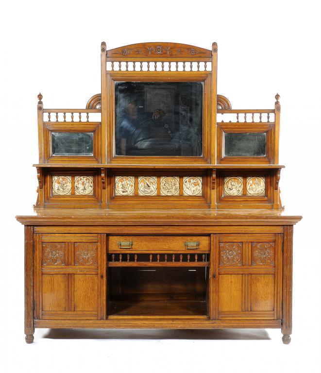 AN ENGLISH REFORMED GOTHIC OAK SIDEBOARD IN THE MANNER OF  BRUCE TALBERT the mirror inset back