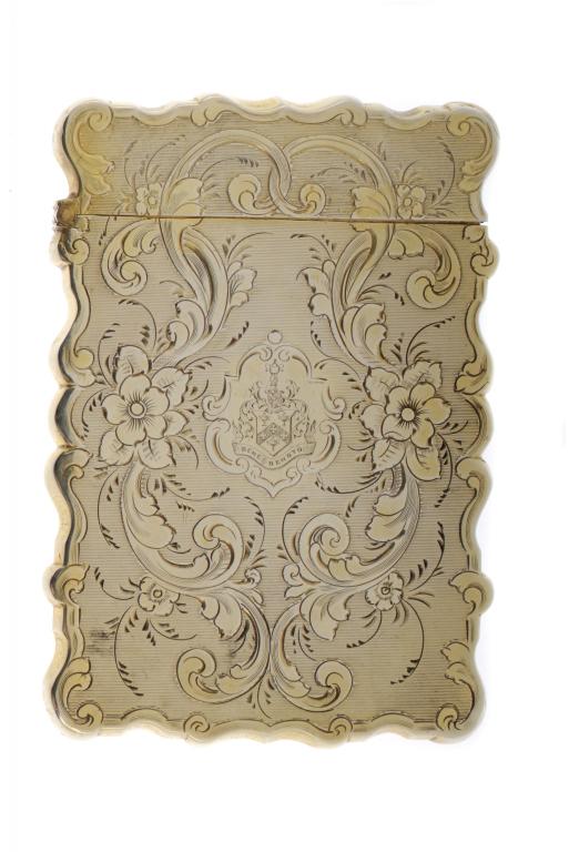 A VICTORIAN SILVER GILT CARD CASE  engraved with contemporary armorials, flowers and entwined