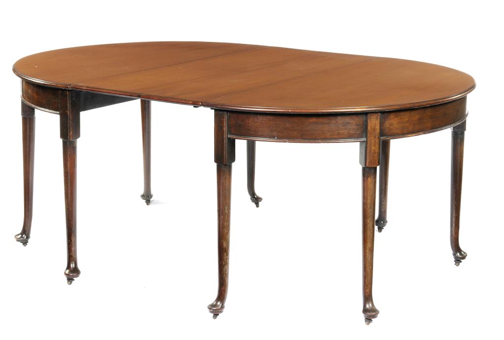 A MAHOGANY DINING TABLE with semi-circular ends, on tapering legs and pad feet with brass castors,