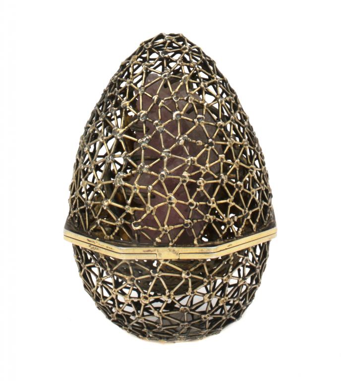 AN ELIZABETH II SILVER GILT EASTER EGG  BY STUART DEVLIN, AO (1931-)  of cagework containing a