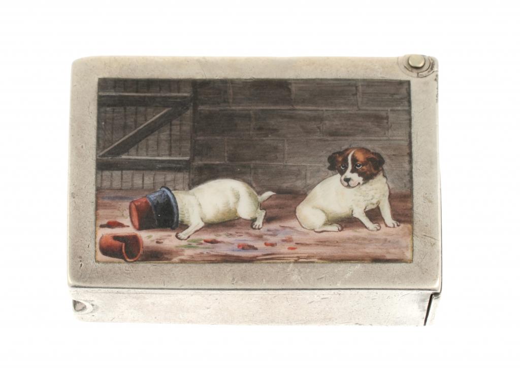 A VICTORIAN SILVER AND ENAMEL VESTA CASE the front painted with two playful puppies, the back