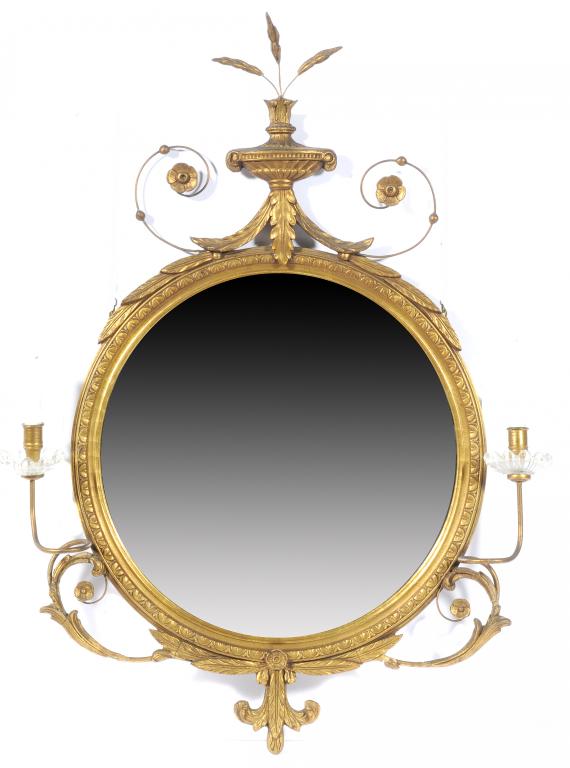 A NEO CLASSICAL STYLE GILTWOOD AND COMPOSITION GIRANDOLE the circular frame crested by an urn and