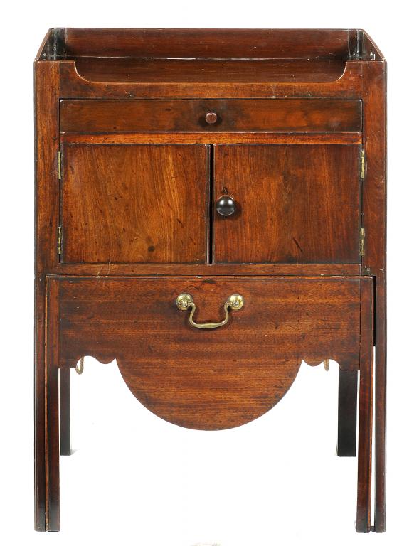 A GEORGE IV MAHOGANY TRAY TOP COMMODE fitted with a drawer above pair of doors and the apron drawer,