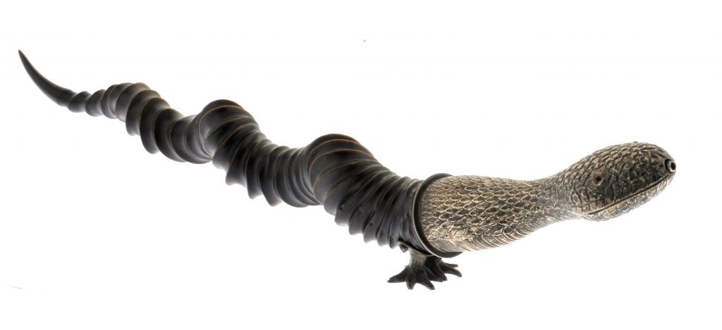 A VICTORIAN SILVER AND RAM`S HORN CIGAR LIGHTER IN THE FORM OF A LIZARD   on two feet, 52cm l, by