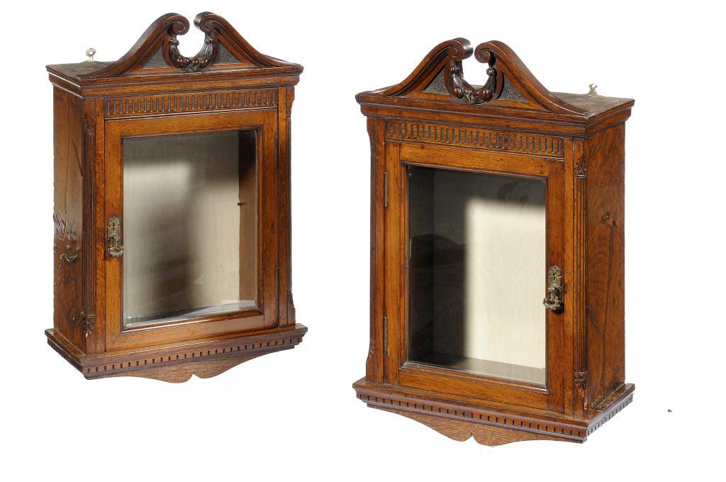 A PAIR OF VICTORIAN CARVED OAK AND POLLARD OAK HANGING CABINETS  with swan neck pediment and fruit