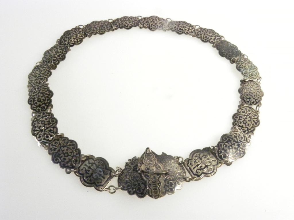 A CAUCASIAN SILVER AND NIELLO BELT, THE WAIST CLASP WITH CYRILLIC INSCRIPTION AND SECURED BY A