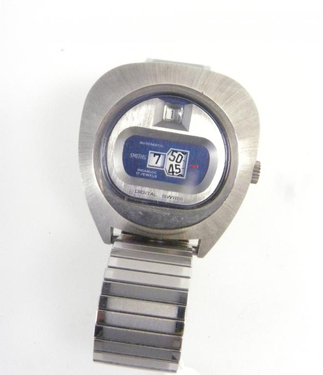 A SMITHS STAINLESS STEEL DIGITAL `BULLHEAD` WRISTWATCH WITH DATE, NUMBERED ON BACK 12635, 1970`S