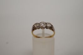 A three stone diamond ring, the graduated stones illusion set, finger size M