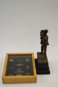 A framed military badge display and figure