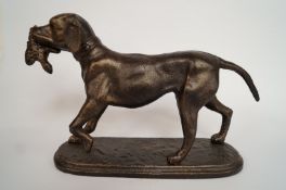 A cast figure of a dog and pheasant