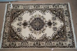 A Tabriz cream and dark brown rug, 138 x 95cm