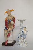 A Jester figurine and a ceramic candle holder