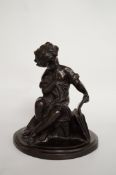 An early 20th century bronze figure of a seated child